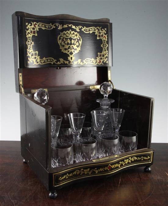 A 19th century French ebony, tortoiseshell and brass inlaid liqueur set, 13in.